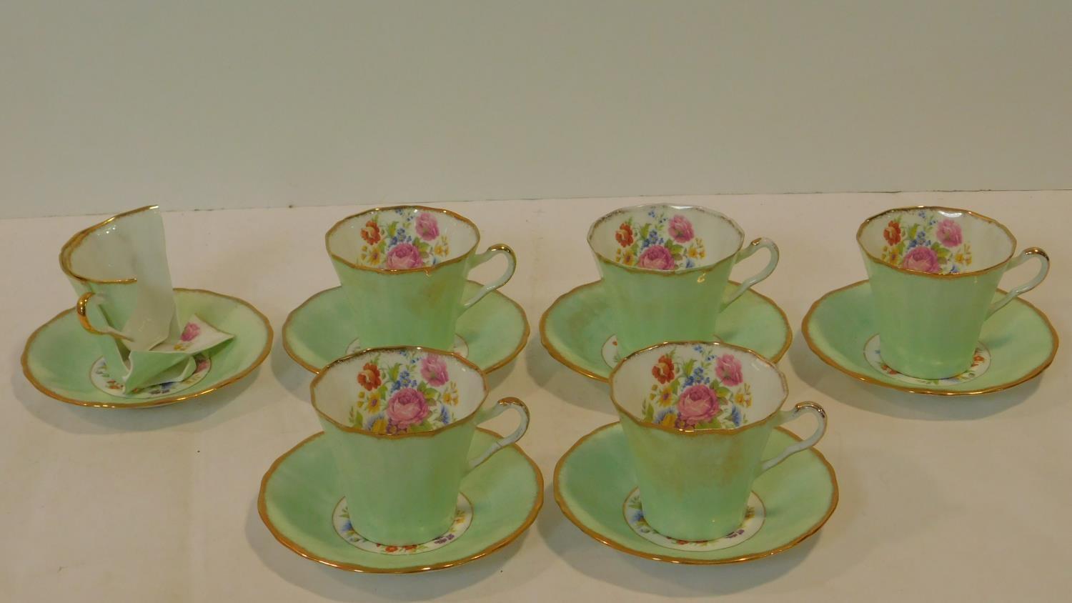 An antique Imperial Bone China five person tea set, gilded with 22kt gold and hand painted with a