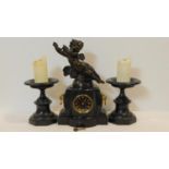 A late 19th century black marble clock garniture, the mantel clock with black enamelled dial and