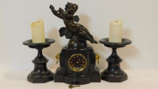 A late 19th century black marble clock garniture, the mantel clock with black enamelled dial and