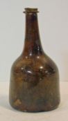 An 18th century brown glass mallet shaped wine bottle. H.19cm