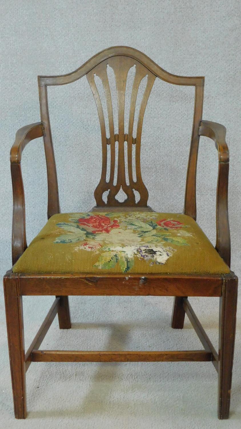 A Georgian mahogany framed armchair with pierced shaped splat above tapestry upholstered drop in