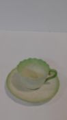 A Belleek 2nd period Irish porcelain waterlilly form tea cup and saucer with pale green detailing to