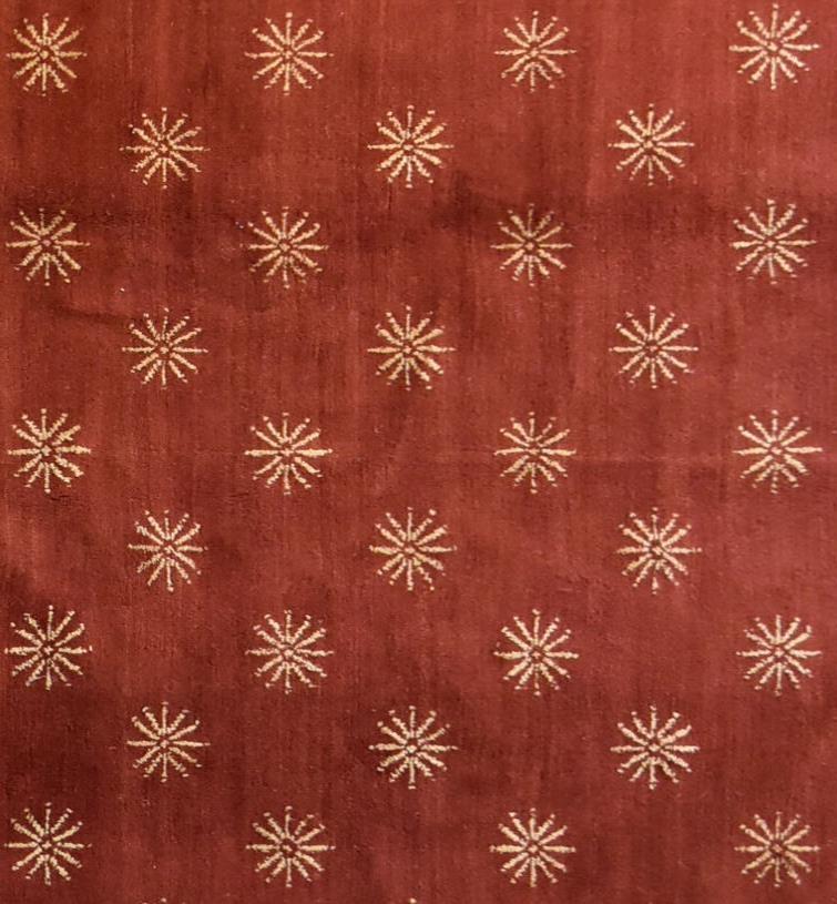 A silk and wool rug with repeating geometric flowerhead design on a burgundy field. L.237x170cm - Image 2 of 3