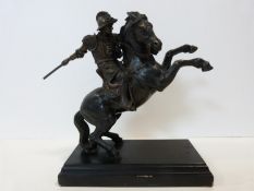 A bronze figure group, Continental armoured cavalryman on a rearing horse on stepped rectangular