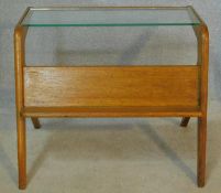 A mid century vintage teak magazine table with plate glass top and open book shelf. H.53 W.65 D.51cm