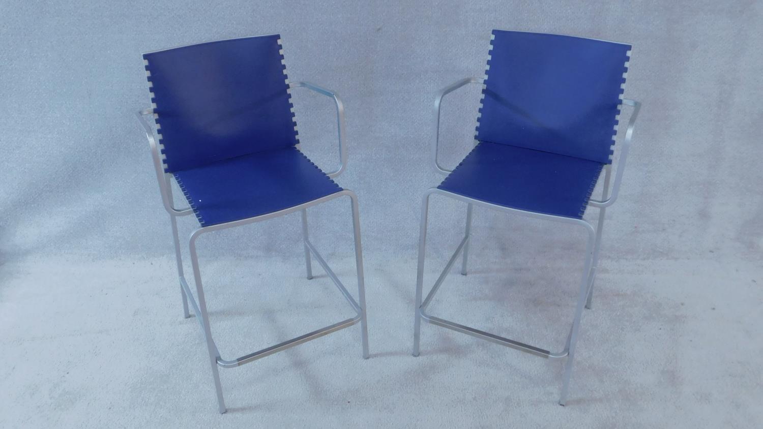 A pair of blue moulded Desalto 'Minotti' Zip high armchairs on tubular metal bases. H.94cm