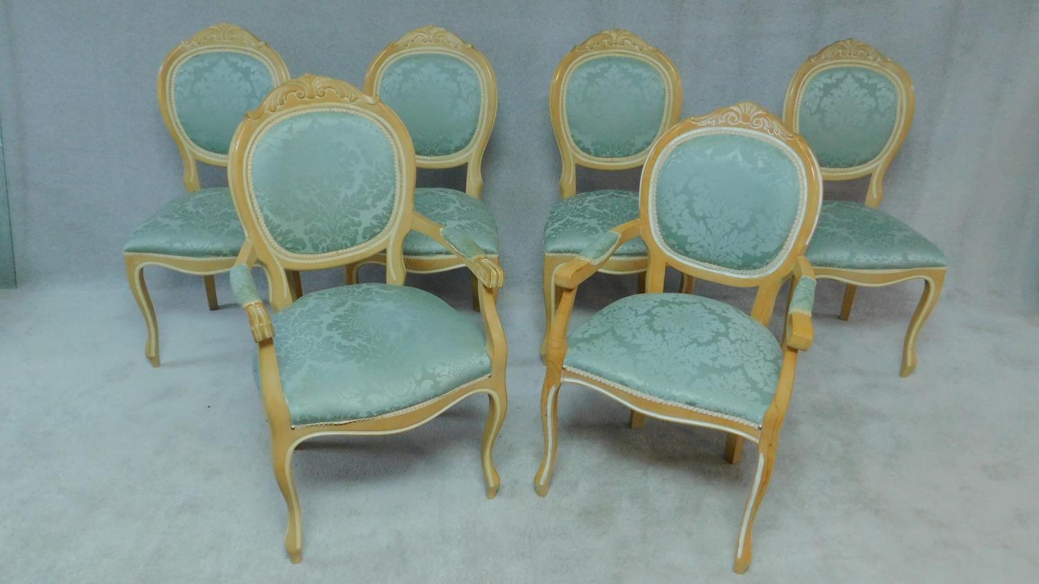 A set of six beech framed Louis XV style dining chairs with highlight to the frames in floral pale