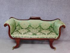 A small Regency mahogany framed scroll arm sofa in newly upholstered emerald floral damask raised on