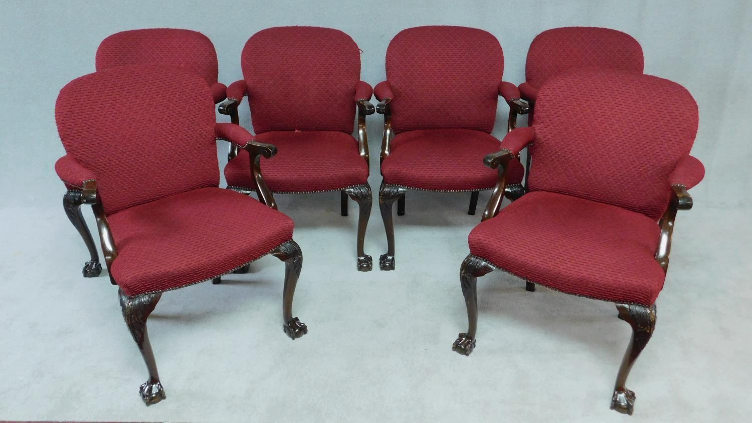 A set of six Georgian style mahogany open armchairs in burgundy cut moquette on carved cabriole