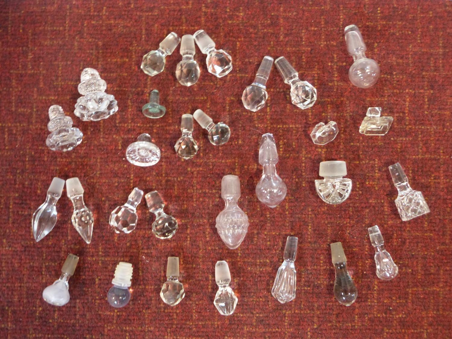 A miscellaneous collection of twenty nine cut crystal and other decanter and scent bottle