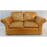 A contemporary two seater sofa in light tan leather upholstery. H.90 W.170 D.98cm