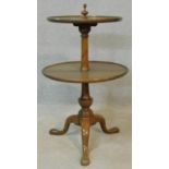 A 19th century mahogany two tier dumb waiter with turned finial to the top and central column on