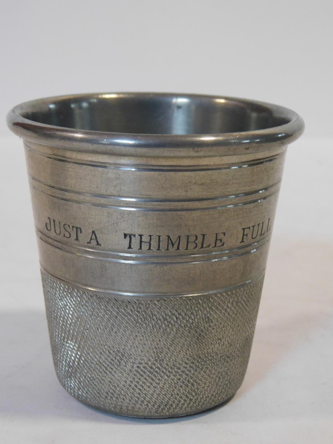 A novelty English pewter thimble form cup engraved 'Just a Thimble Full' along with a silver - Image 2 of 3
