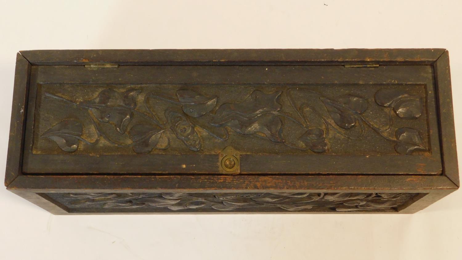 A late 19th century oak stationery casket with Arts and Crafts style floral carved panels. H.22 W.50 - Image 3 of 8