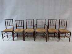 A set of six beech Sussex style chairs in the manner of Morris and Co. with spindle backs and