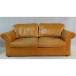 A contemporary two seater sofa bed in light tan leather upholstery. H.70 W.205 D.100cm