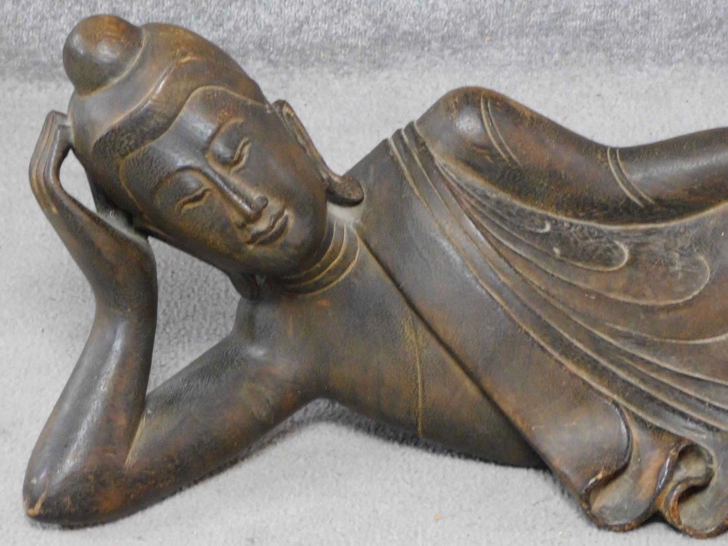 An early to mid 20th century Burmese carved hardwood reclining Buddha. With intricately carved - Image 2 of 5