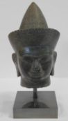 A Southeast Asian carved hardstone head of Vishnu with serene face, open eyes, elongated earlobes,