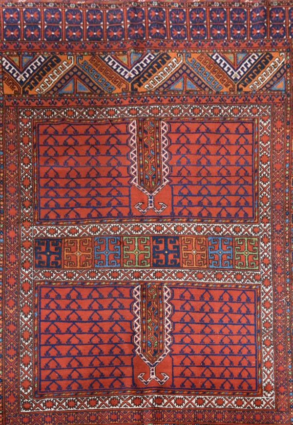 An Afghan rug with geometric design across the madder field within stylised floral borders. L. - Image 2 of 4