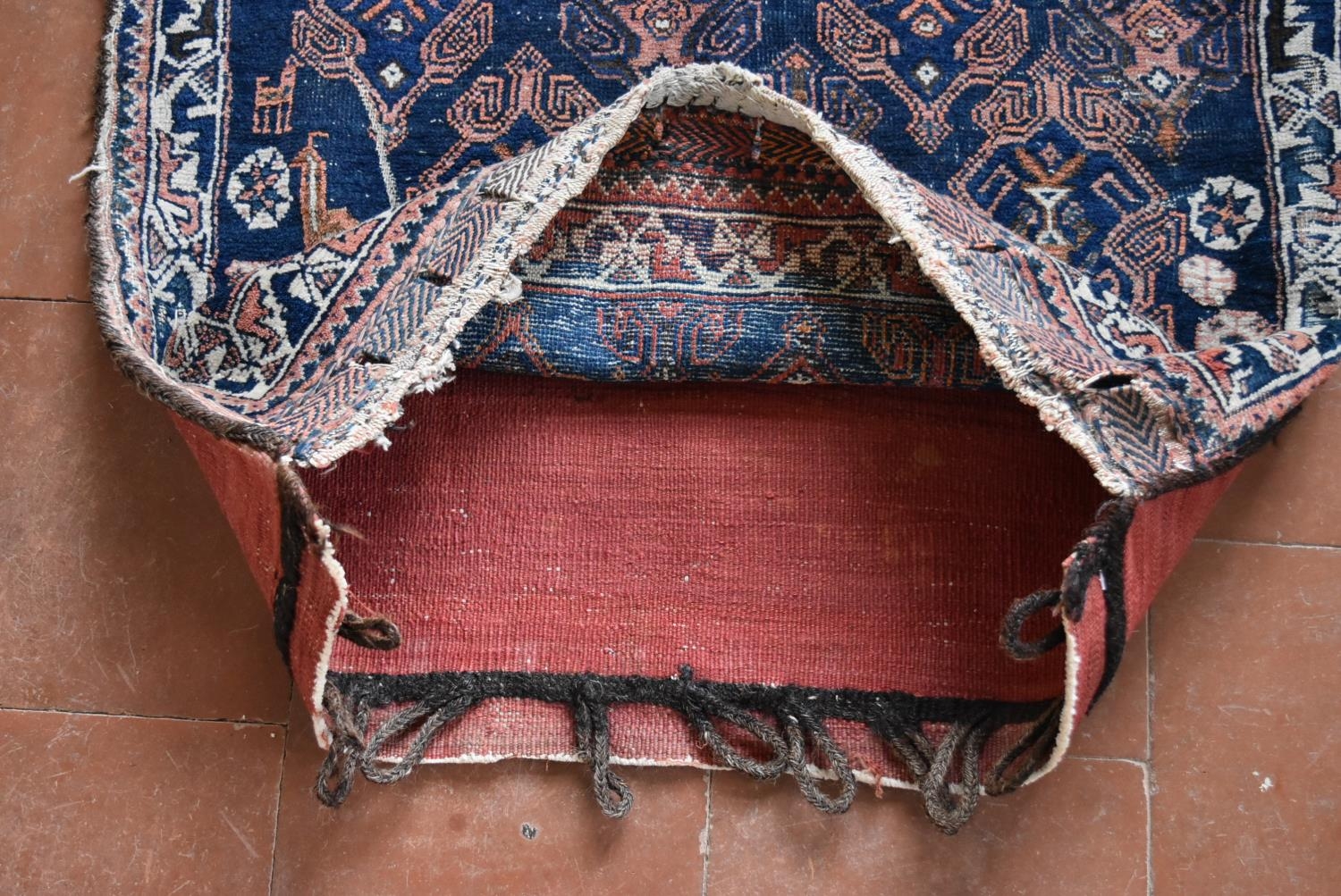 An antique Balouch saddle bag with repeating stylised floral design on midnight ground. L.72xW.65cm - Image 4 of 4