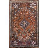 A Persian Shiraz rug with double pendant medallion within stepped flowerhead spandrels and