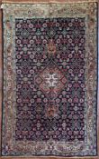 A Persian Tabriz rug with stepped central medallion on a midnight field with all over floral