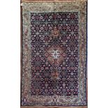 A Persian Tabriz rug with stepped central medallion on a midnight field with all over floral