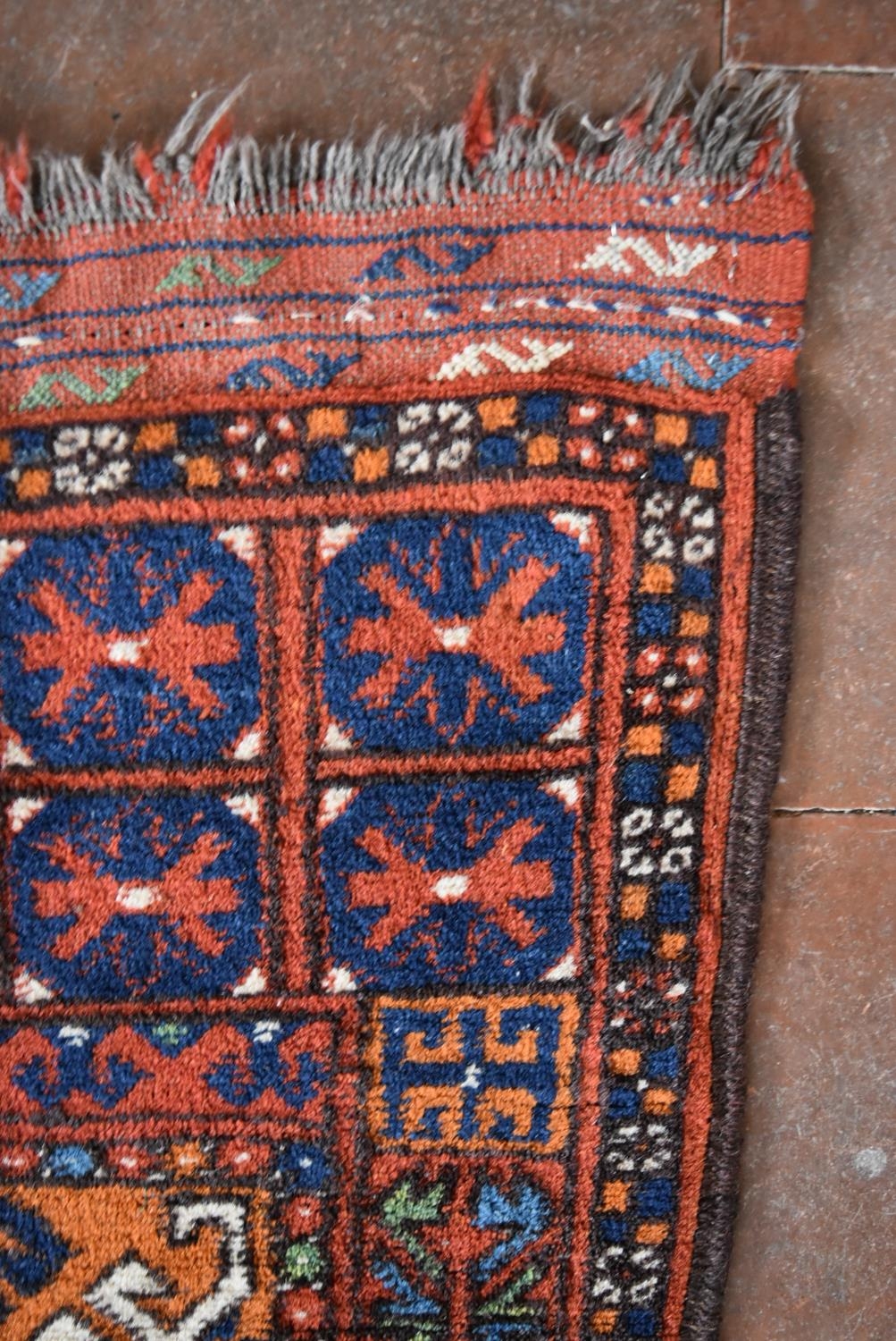 An Afghan rug with geometric design across the madder field within stylised floral borders. L. - Image 3 of 4