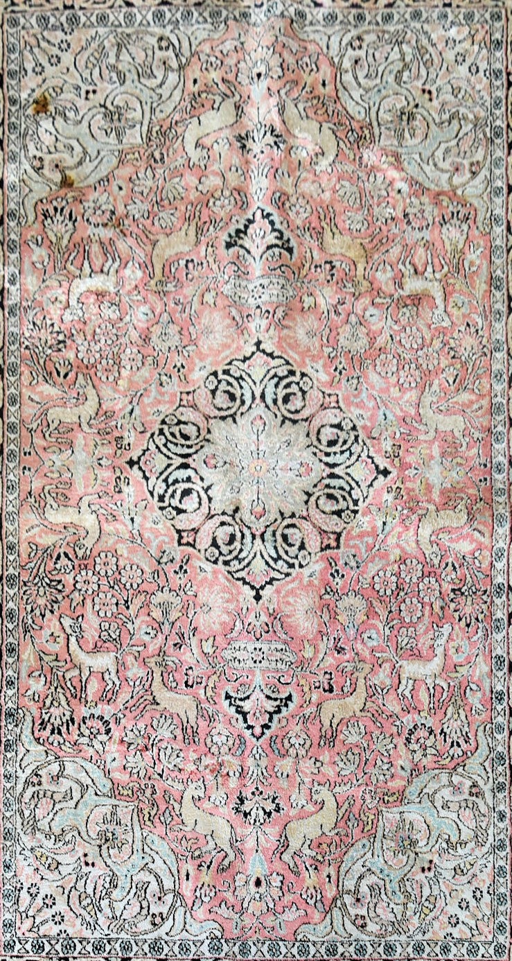 a Kashmir silk rug with floral medallion and spandrels on a salmon ground depicting animals in a - Image 2 of 4