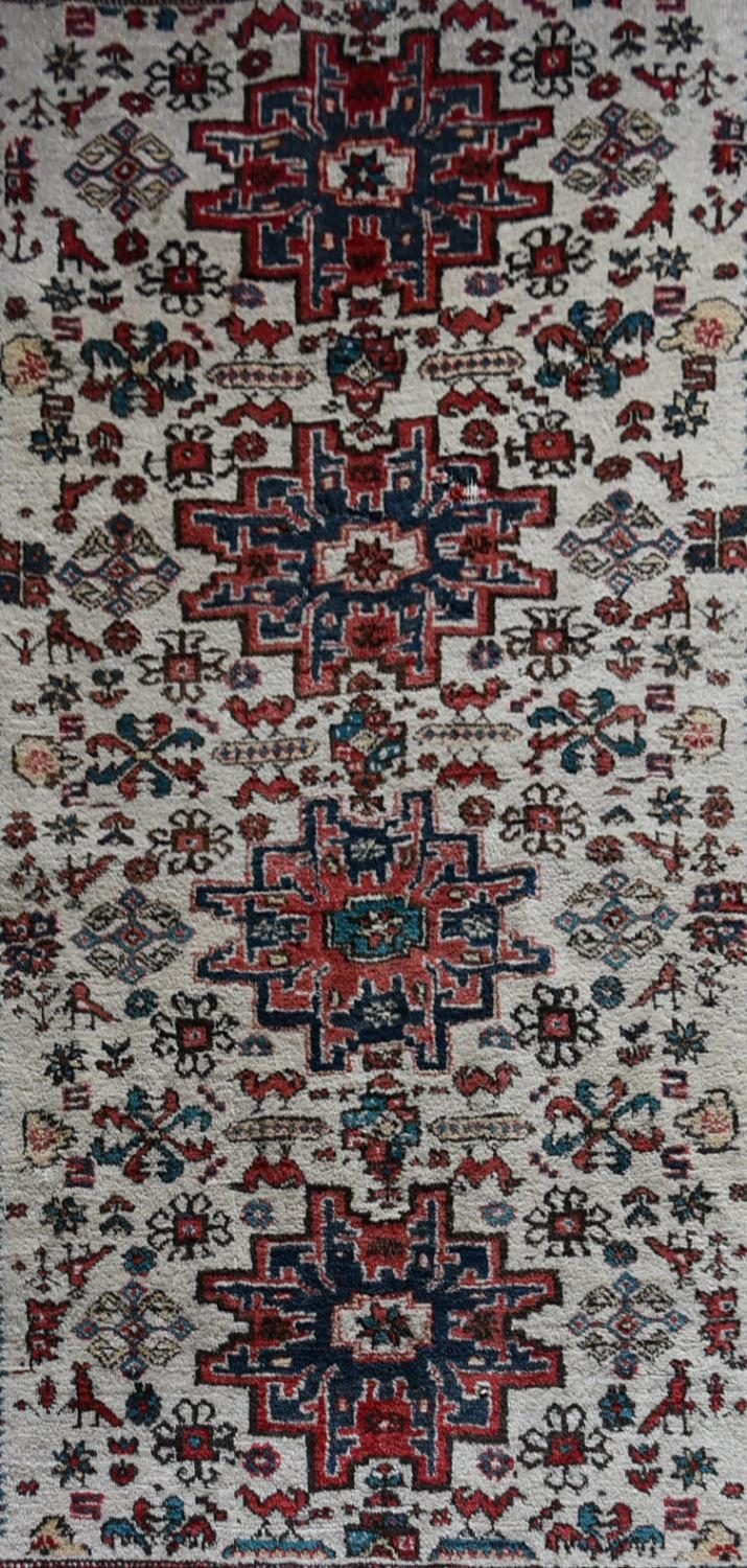 A Turkish Rug with repeating central medallions on ivory ground within stylised floral multi - Image 2 of 4