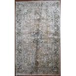 A silk Kashmir rug with central pendant medallion and scrolling floral design on a pale pink