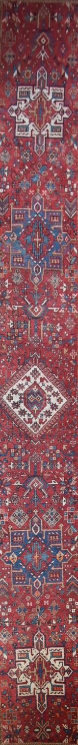 An antique Persian Heriz runner with repeating star medallions on a madder ground enclosed by - Image 2 of 4