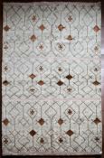 A Moroccan style rug with repeating stylised star pattern within a geometric design across the