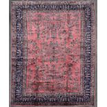 A Persian Sarogh style carpet with meandering vine, lotus flower and palmette decoration across