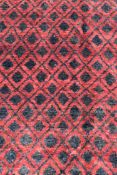 A modern rug with all over repeating diamond pattern on a rouge ground. L.190xW.125cm