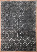 A modern rug with scrolling lattice design on a charcoal ground. L.197xW.147cm