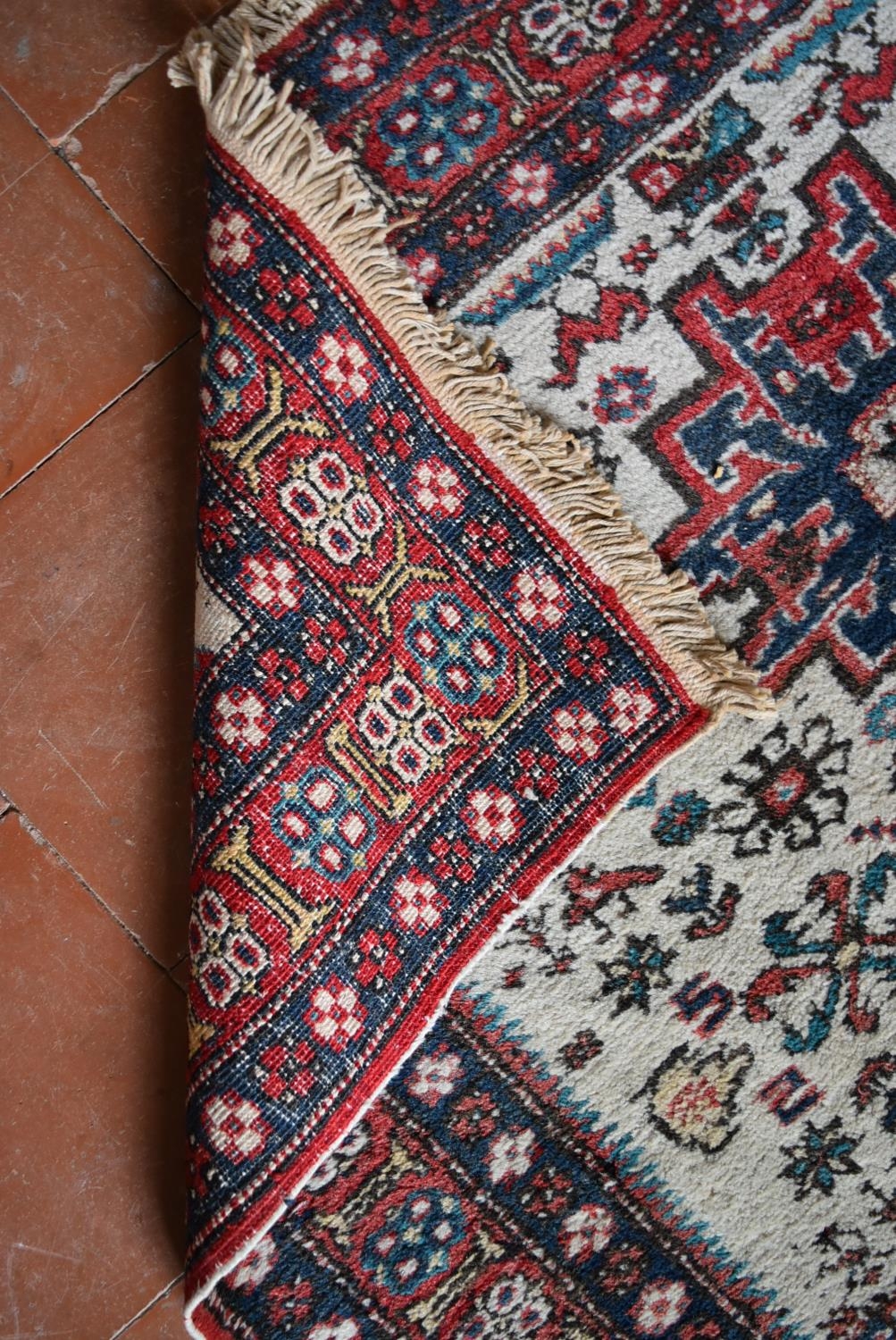 A Turkish Rug with repeating central medallions on ivory ground within stylised floral multi - Image 4 of 4