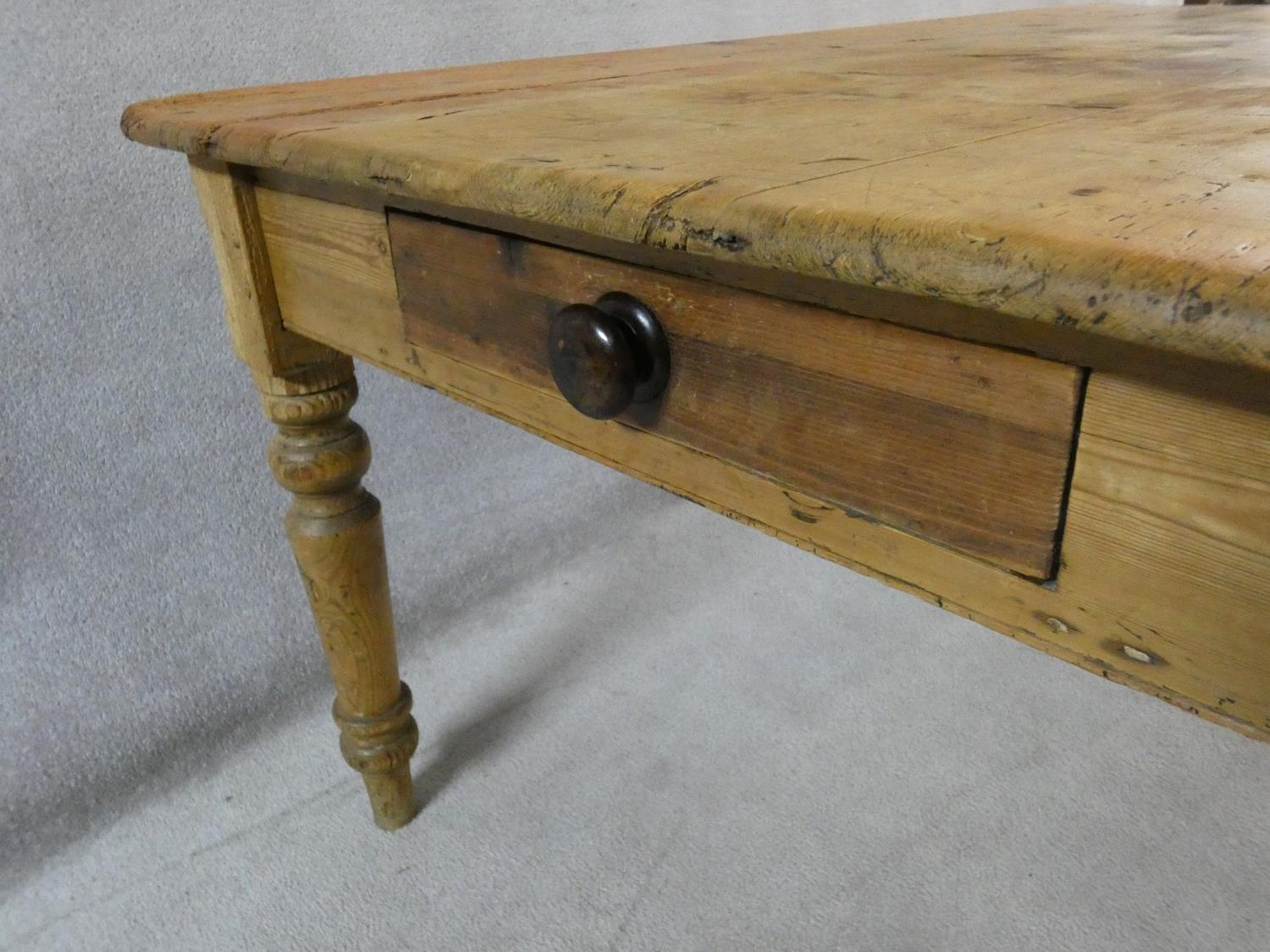 A Victorian pine kitchen dining table with planked top and end drawer on turned tapering supports. - Image 7 of 16