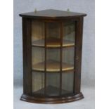 A small 19th century mahogany bowfronted corner cabinet with astragal glazed door. 66x48cm