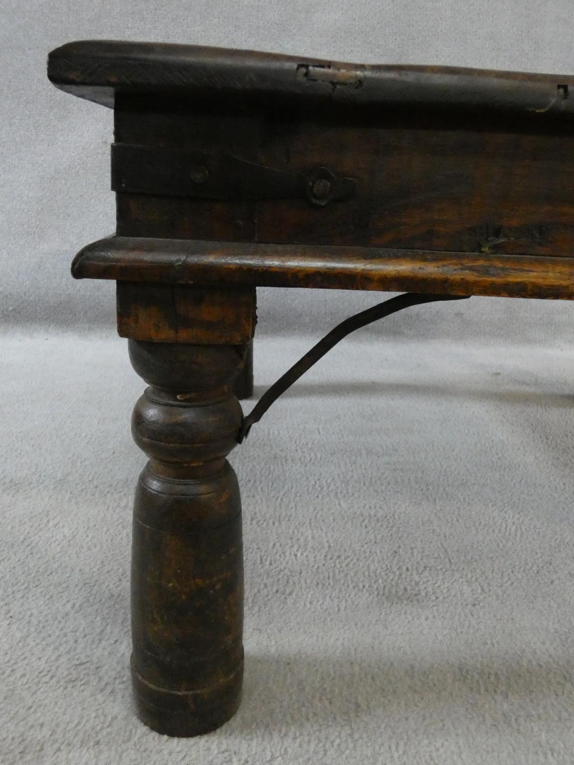 An Indian iron bound hardwood low table on circular section supports. H.42xW.80xL.80cm - Image 6 of 9