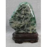 A large polished Fluorite crystal boulder mounted on a carved Chinese wooden stand. H.31cm