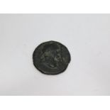 An ancient bronze Roman coin with a winged figure on one side and Roman male bust on the other. D.