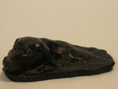 A patinated brass sculpture of a dogs head, possibly while swimming. Signed PB. H.5 W.18 D.15cm