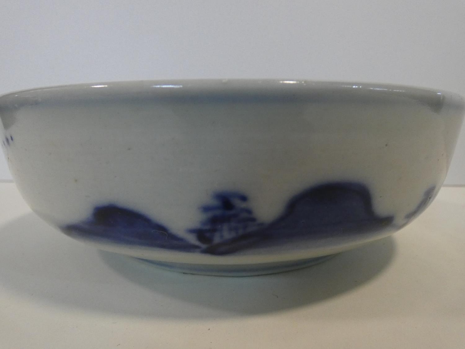 A Meji period blue and white ceramic Japanese bowl with hand painted village scene with mountains in - Image 6 of 8