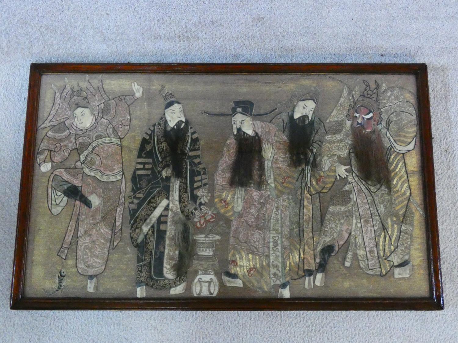 An early 20th century oak framed and glazed Chinese silk embroidery of noblemen and their attendants