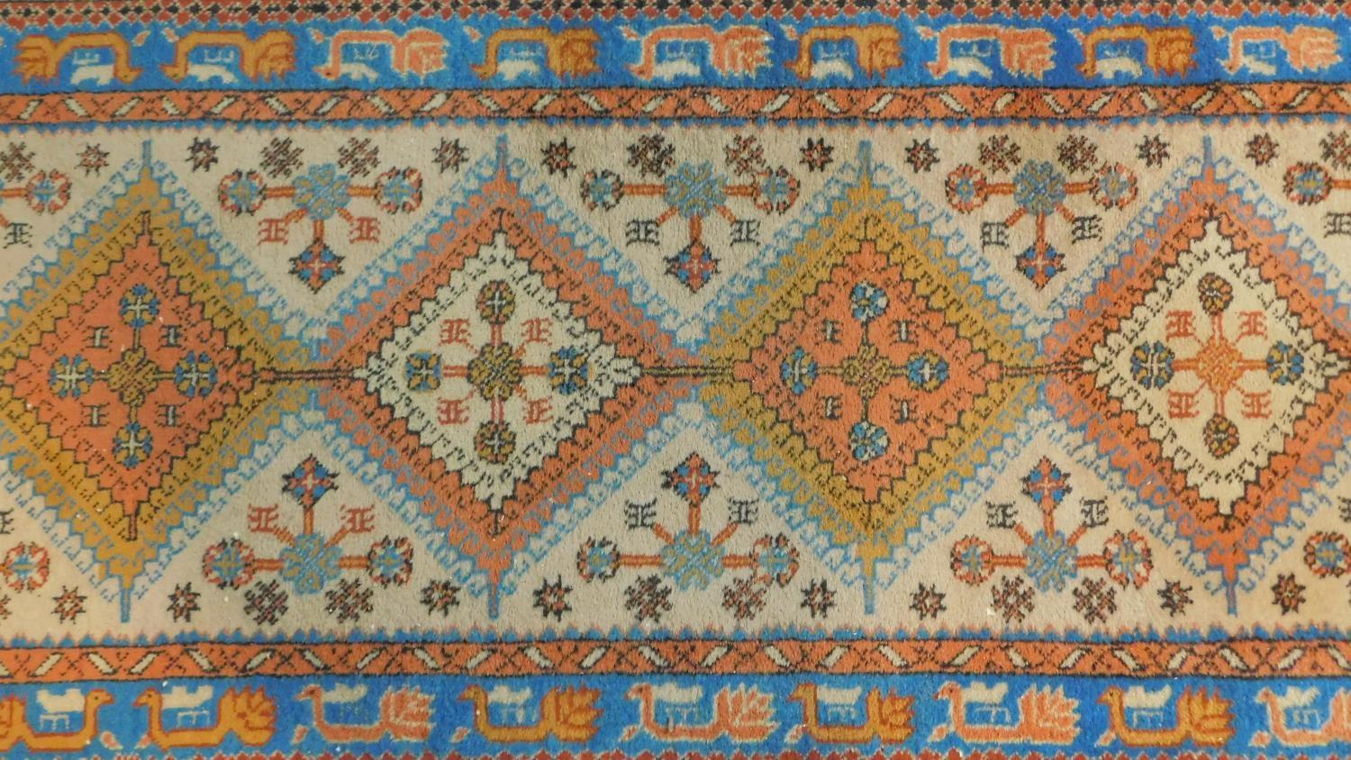 A Turkish Usak runner with repeating diamond medallions on a cream ground within an azure bird and - Image 2 of 4