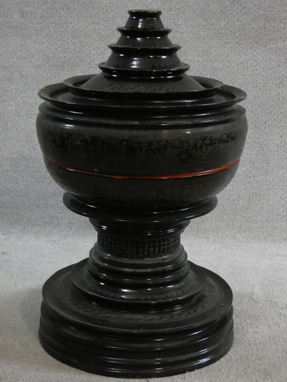 A lacquered and engraved Burmese food offering vessel (Hsunok) with removable lid. It has a red