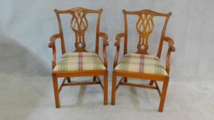 A pair of Chippendale style mahogany open armchairs with carved back splats and drop in seats on