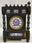 A late 19th century ebonised Gothic style bracket clock with blue and white ceramic dial and