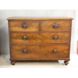 A 19th century mahogany chest of two short over three long drawers with knob handles on turned feet.